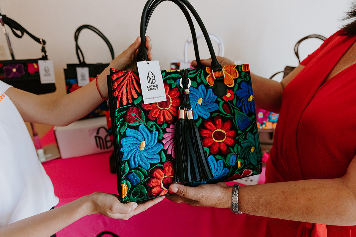 women holding embroidered leather bag